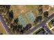 Bird's-eye view of tennis and basketball courts within a community, set amidst mature trees and manicured lawns at 690 Cascading Creek Ln, Winter Garden, FL 34787
