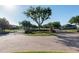 Grand community entrance with brick-paved roundabout, decorative landscaping, and secure gated access at 690 Cascading Creek Ln, Winter Garden, FL 34787