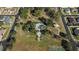 Aerial perspective of a community park featuring a pool, picnic area, and sports court, surrounded by residential homes at 690 Cascading Creek Ln, Winter Garden, FL 34787