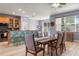 Dining room with breakfast bar, modern light fixture, and sliding glass doors at 690 Cascading Creek Ln, Winter Garden, FL 34787