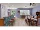 Open-concept dining room with elegant lighting, hardwood floors, and access to backyard at 690 Cascading Creek Ln, Winter Garden, FL 34787