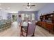 Open-concept dining room with elegant lighting, hardwood floors, and backyard access at 690 Cascading Creek Ln, Winter Garden, FL 34787
