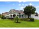 Beautifully landscaped home showcasing a manicured lawn, trimmed hedges, and a welcoming front porch at 690 Cascading Creek Ln, Winter Garden, FL 34787