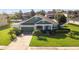 Charming single-Gathering home featuring lush landscaping, a well-manicured lawn, and an attached garage at 690 Cascading Creek Ln, Winter Garden, FL 34787