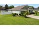Inviting single-story home with a green lawn, beautiful landscaping, and fenced in yard at 690 Cascading Creek Ln, Winter Garden, FL 34787