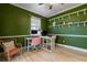 Stylish home office featuring green walls, white trim, floating shelves, and contemporary decor at 690 Cascading Creek Ln, Winter Garden, FL 34787