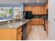An open kitchen with oak cabinets, stainless steel appliances, and tile backsplash at 690 Cascading Creek Ln, Winter Garden, FL 34787