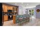 Open kitchen with wood cabinets, breakfast bar, and stainless steel appliances at 690 Cascading Creek Ln, Winter Garden, FL 34787