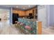 Open kitchen with wood cabinets, breakfast bar, and stainless steel appliances at 690 Cascading Creek Ln, Winter Garden, FL 34787