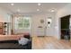 Bright living room with stylish decor, modern furniture, wood floors, and ample natural light at 690 Cascading Creek Ln, Winter Garden, FL 34787