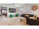 Bright living room featuring modern decor, hardwood floors, and lots of natural light at 690 Cascading Creek Ln, Winter Garden, FL 34787