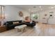 Living room with a grey sectional sofa, hardwood floors, and modern decor at 690 Cascading Creek Ln, Winter Garden, FL 34787