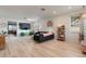 Spacious open-concept living room with wood floors, modern decor, and plenty of natural light at 690 Cascading Creek Ln, Winter Garden, FL 34787