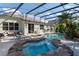 Resort style pool with hot tub and beautiful landscaping viewed from rear exterior at 690 Cascading Creek Ln, Winter Garden, FL 34787