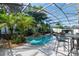 Resort-style backyard boasts a private pool surrounded by lush, tropical landscaping at 690 Cascading Creek Ln, Winter Garden, FL 34787