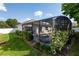 Beautiful outdoor pool with screened enclosure, surrounded by lush landscaping and a cozy patio area at 690 Cascading Creek Ln, Winter Garden, FL 34787