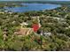 Real estate location pin on aerial view of home surrounded by mature trees and lake at 9500 Shortleaf Ct, Apopka, FL 32703