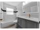 Well-lit bathroom featuring a tub with shower, vanity with sink, and modern fixtures for comfortable living at 1111 Brielle Ct, Oviedo, FL 32765