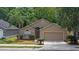 A single-Gathering home featuring a two-car garage, manicured lawn, and a welcoming front entrance at 1111 Brielle Ct, Oviedo, FL 32765
