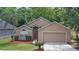Exterior shot of a charming single-Gathering home with a well-kept lawn and a two-car garage at 1111 Brielle Ct, Oviedo, FL 32765