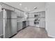 Modern kitchen with stainless steel appliances, sleek gray cabinets, and tiled backsplash, ideal for cooking enthusiasts at 1111 Brielle Ct, Oviedo, FL 32765