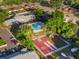 Aerial view showcasing community amenities, including a pool, playground, and basketball court in a lush setting at 1227 Carriage Ln, Orlando, FL 32807