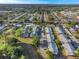 Wide aerial view of a residential neighborhood, showing apartment complexes surrounded by mature trees at 1227 Carriage Ln, Orlando, FL 32807