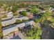 Attractive aerial view of an apartment complex with a swimming pool, parking, and recreation court surrounded by green trees at 1227 Carriage Ln, Orlando, FL 32807