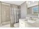 Updated bathroom with a shower-tub combination and new vanity with granite countertop at 1227 Carriage Ln, Orlando, FL 32807