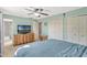 Comfortable bedroom offering soft carpet, ceiling fan, and a nearby attached bathroom at 1227 Carriage Ln, Orlando, FL 32807