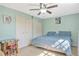 Light-filled bedroom features soft carpet, closet space, and stylish ceiling fan at 1227 Carriage Ln, Orlando, FL 32807
