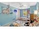 Colorful bedroom offering two beds, a tv, large window, and closet at 1227 Carriage Ln, Orlando, FL 32807