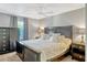 Stylish bedroom featuring modern furniture, a large window, and a modern ceiling fan at 1227 Carriage Ln, Orlando, FL 32807
