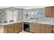 Functional kitchen features a double sink and plenty of natural light from the window at 1227 Carriage Ln, Orlando, FL 32807