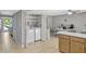Bright laundry area with modern washer and dryer, shelving and a view of the kitchen area at 1227 Carriage Ln, Orlando, FL 32807