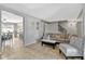 Inviting living room featuring tile floors, gray paint, and access to dining room and staircase at 1227 Carriage Ln, Orlando, FL 32807