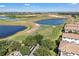 Aerial view of a beautiful golf course community featuring manicured greens, water features and golf carts at 1339 Shinnecock Hills Dr, Davenport, FL 33896
