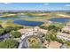 Aerial view of a luxurious community clubhouse, golf course and ponds, perfect for recreation at 1339 Shinnecock Hills Dr, Davenport, FL 33896