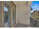 Balcony featuring a metal railing and door with blinds at 1339 Shinnecock Hills Dr, Davenport, FL 33896