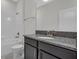 This bathroom features granite countertops, a tub, toilet and updated fixtures at 1339 Shinnecock Hills Dr, Davenport, FL 33896