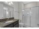 This bathroom features a granite countertop, glass shower and updated fixtures at 1339 Shinnecock Hills Dr, Davenport, FL 33896
