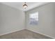 This bedroom features neutral walls, carpet, a window with blinds and overhead lighting at 1339 Shinnecock Hills Dr, Davenport, FL 33896