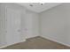 This bedroom features neutral walls, carpet, two white doors and overhead lighting at 1339 Shinnecock Hills Dr, Davenport, FL 33896