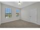 This bedroom features neutral walls, carpet, windows with blinds and a white door at 1339 Shinnecock Hills Dr, Davenport, FL 33896