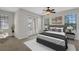 Bedroom featuring a ceiling fan, a cozy bed with two side tables, and natural light at 1339 Shinnecock Hills Dr, Davenport, FL 33896