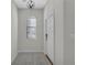 Clean entryway with tile flooring, a white door, and a light fixture at 1339 Shinnecock Hills Dr, Davenport, FL 33896