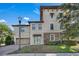 Charming townhome featuring an attached garage, covered entryway, and lush landscaping at 1339 Shinnecock Hills Dr, Davenport, FL 33896