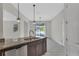 Modern kitchen featuring granite countertops, a stainless steel sink, and modern lighting at 1339 Shinnecock Hills Dr, Davenport, FL 33896