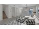 Bright living room with neutral walls, a modern chandelier, and tile floors at 1339 Shinnecock Hills Dr, Davenport, FL 33896