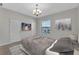 This bedroom features neutral walls, carpet, a window with blinds and a TV at 1339 Shinnecock Hills Dr, Davenport, FL 33896